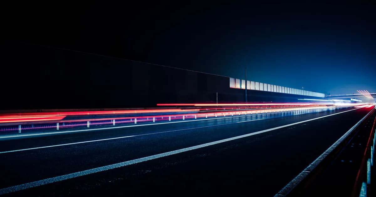 Vibrant long exposure photo capturing light streaks on a highway at night