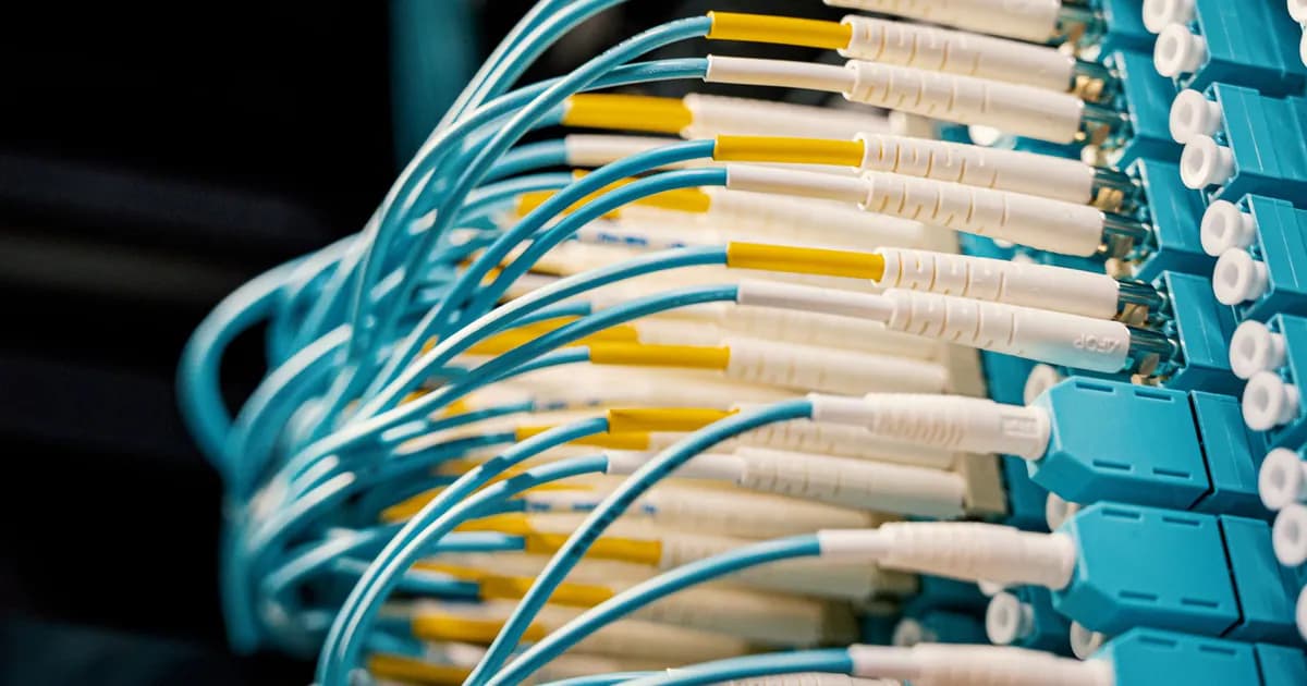 High angle of fiber optical switch with connected cables in modern server room